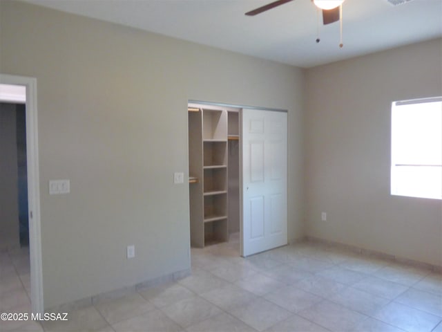 unfurnished bedroom featuring ceiling fan, baseboards, and a closet