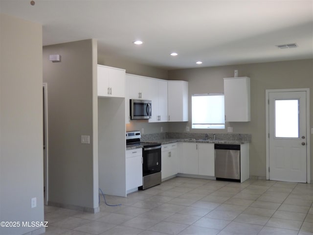 kitchen with stainless steel appliances, recessed lighting, white cabinetry, and visible vents