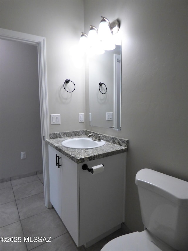 half bath featuring vanity, toilet, and tile patterned floors