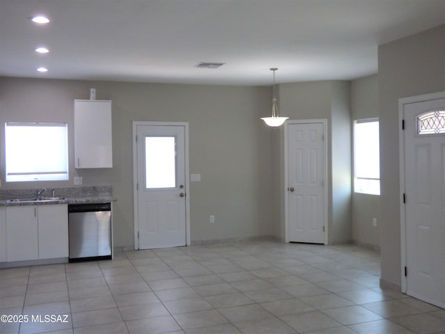 kitchen with plenty of natural light, white cabinets, hanging light fixtures, and stainless steel dishwasher