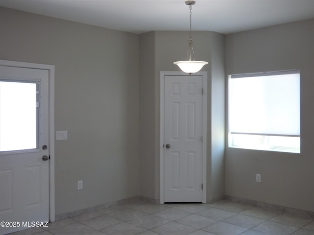 entryway featuring light tile patterned floors and baseboards