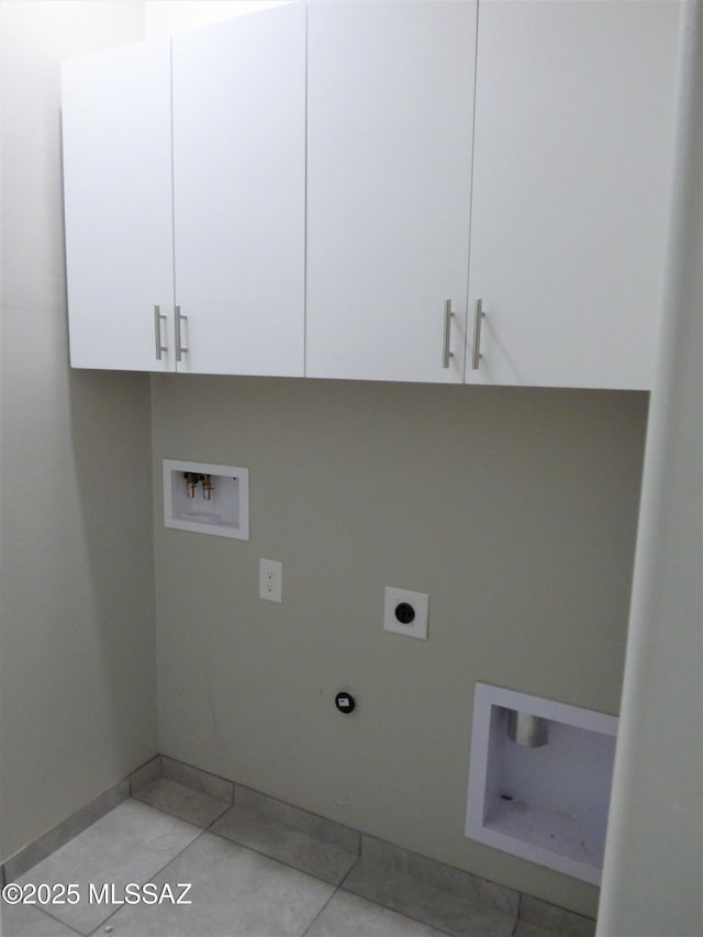 washroom with light tile patterned floors, washer hookup, cabinet space, and electric dryer hookup