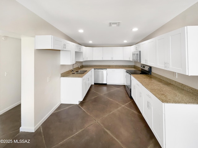 kitchen featuring lofted ceiling, appliances with stainless steel finishes, sink, and white cabinets