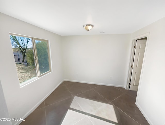 empty room featuring dark tile patterned flooring