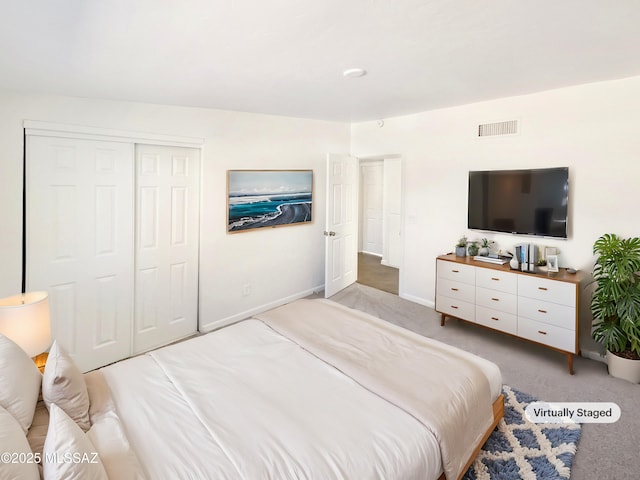 bedroom with carpet and a closet