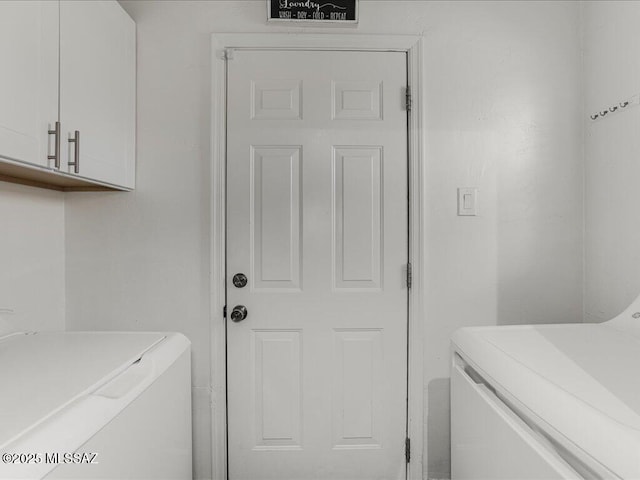 washroom with cabinets and separate washer and dryer