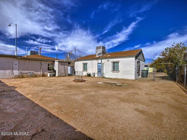 rear view of property with central AC unit