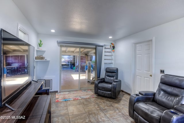 living area with baseboards, recessed lighting, and a healthy amount of sunlight