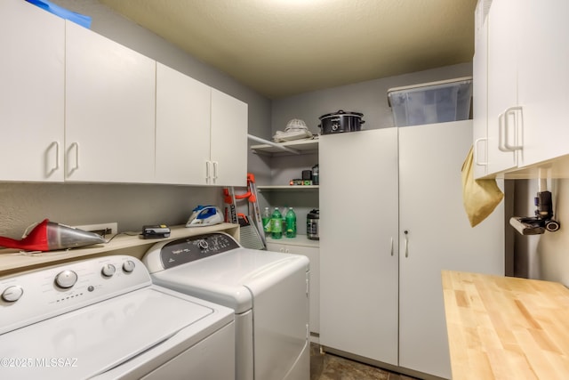 laundry area featuring washing machine and dryer and cabinet space