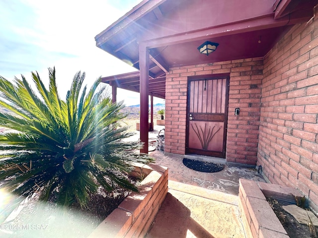 property entrance featuring brick siding