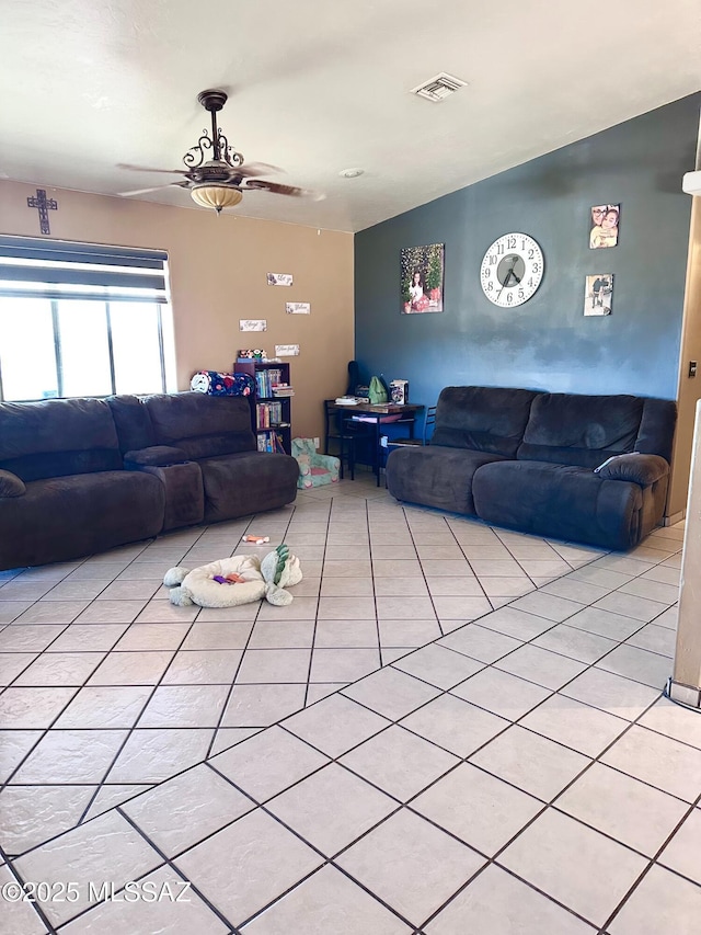 living area with a ceiling fan, visible vents, and light tile patterned flooring