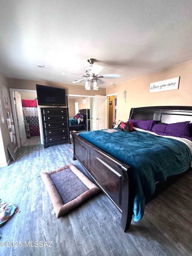 bedroom with a ceiling fan and wood finished floors