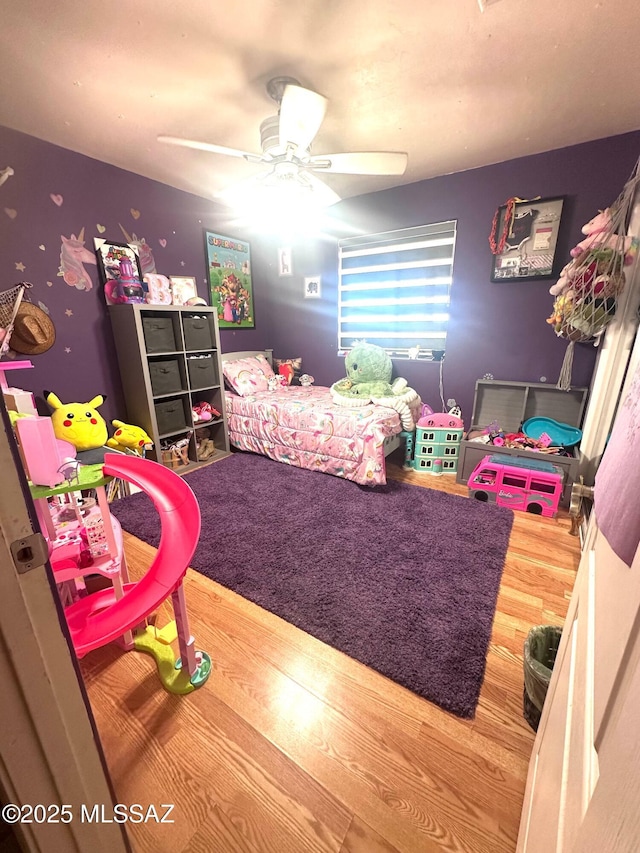 bedroom with a ceiling fan and wood finished floors