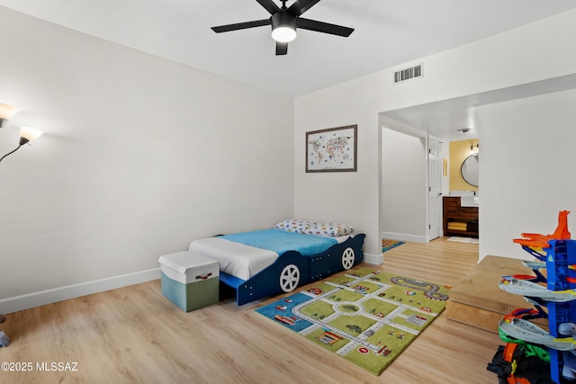 bedroom with light hardwood / wood-style flooring and ceiling fan