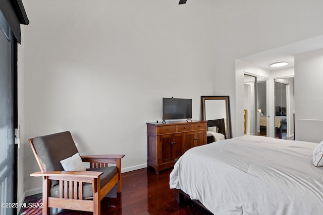 bedroom with dark hardwood / wood-style flooring