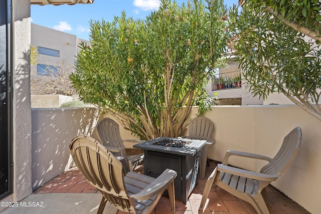 balcony featuring an outdoor fire pit