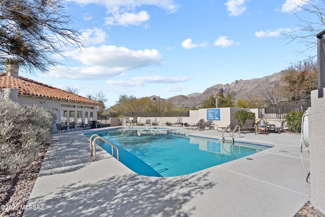 view of pool featuring a mountain view and a patio