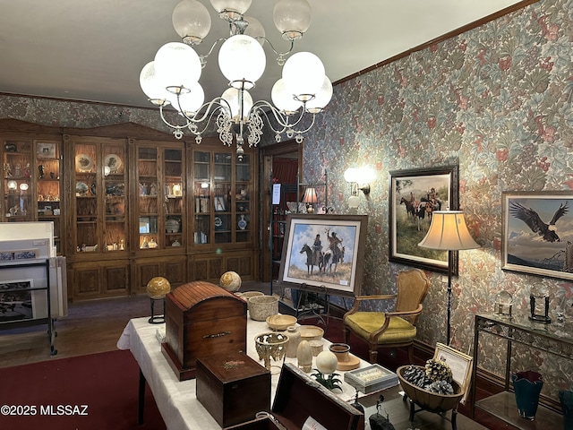 dining area featuring crown molding, an inviting chandelier, wood finished floors, and wallpapered walls