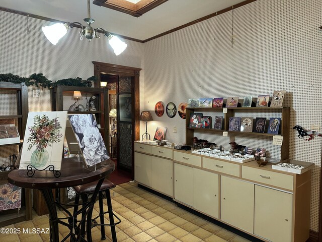 kitchen with light countertops, cream cabinets, open shelves, and wallpapered walls