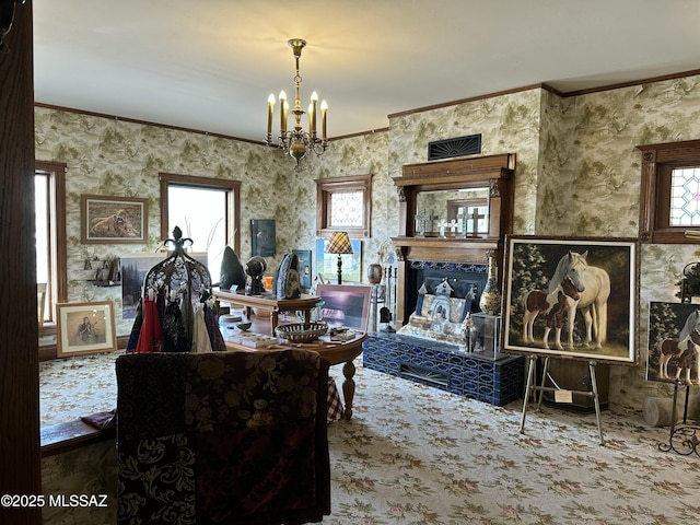 interior space featuring a fireplace, ornamental molding, and a notable chandelier