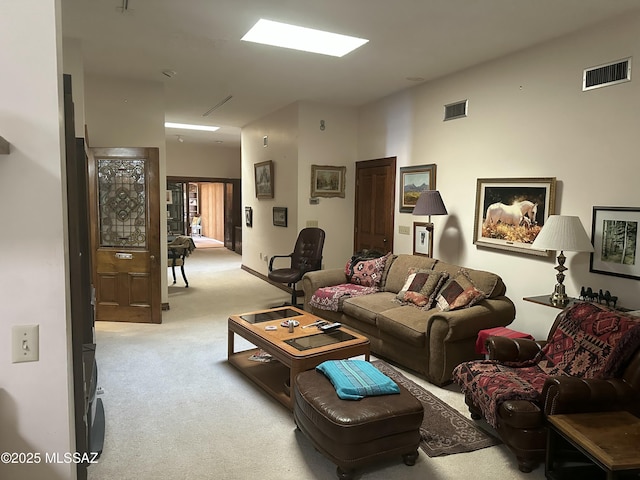 living area with light carpet and visible vents