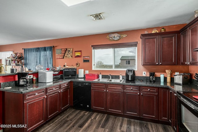 kitchen featuring a healthy amount of sunlight, dark hardwood / wood-style floors, sink, and black appliances