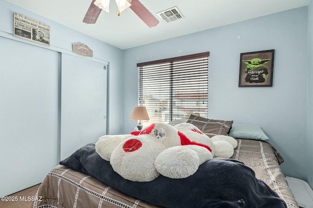 bedroom with ceiling fan and a closet