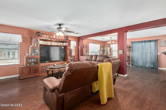 living room featuring dark hardwood / wood-style floors and ceiling fan with notable chandelier