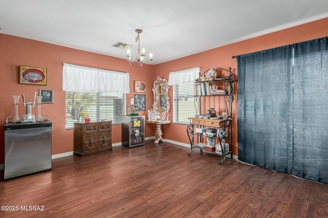 misc room featuring dark hardwood / wood-style flooring and a chandelier