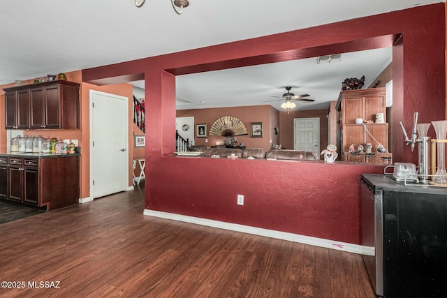 kitchen featuring ceiling fan and dark hardwood / wood-style flooring