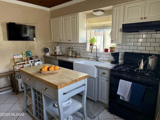 kitchen with sink, wooden counters, ornamental molding, decorative backsplash, and black appliances