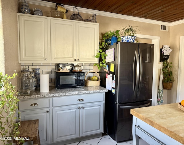 kitchen with tasteful backsplash, white cabinets, stainless steel fridge, ornamental molding, and wooden ceiling