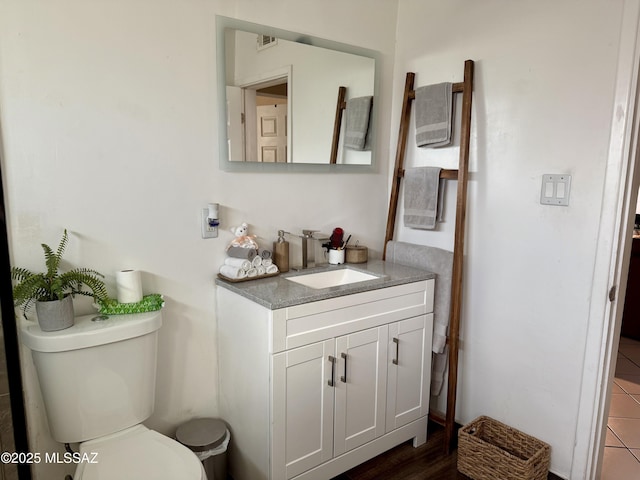 bathroom featuring vanity and toilet