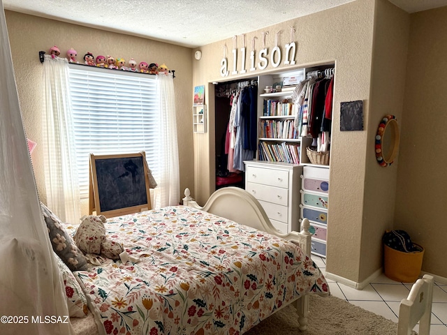 tiled bedroom featuring a textured ceiling