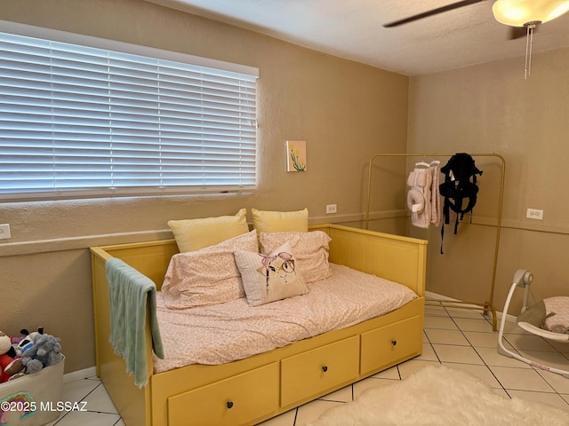 bedroom featuring light tile patterned flooring and ceiling fan