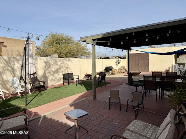 view of patio / terrace featuring a grill and a storage shed