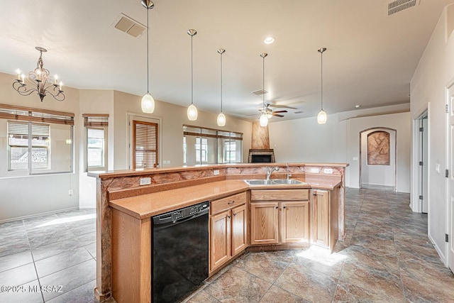 kitchen featuring sink, hanging light fixtures, dishwasher, an island with sink, and ceiling fan with notable chandelier