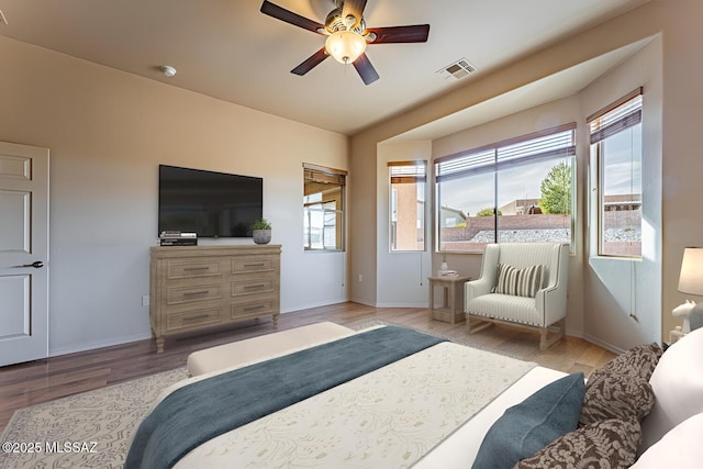 bedroom with ceiling fan and light wood-type flooring