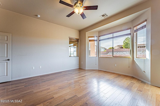 spare room with ceiling fan and light wood-type flooring