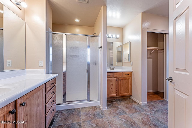 bathroom with vanity and a shower with shower door