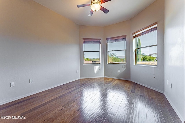 spare room featuring wood-type flooring and ceiling fan