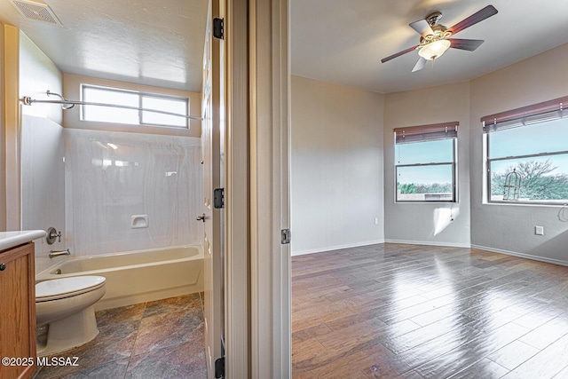 full bathroom with toilet, bathtub / shower combination, vanity, hardwood / wood-style flooring, and ceiling fan