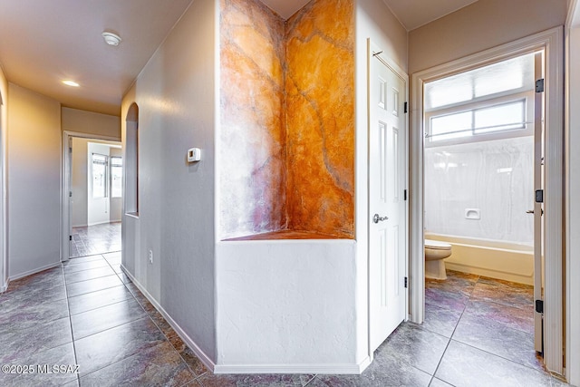 hallway featuring a wealth of natural light