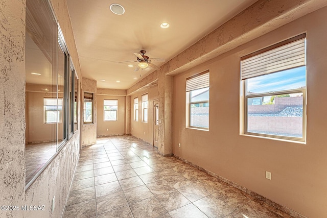 unfurnished room with ceiling fan and light tile patterned floors