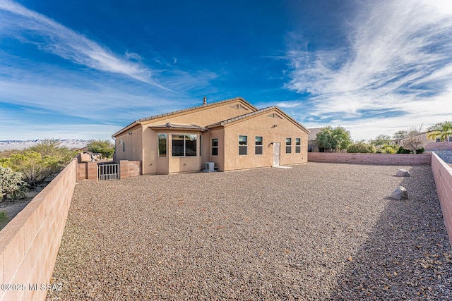 rear view of property with central air condition unit