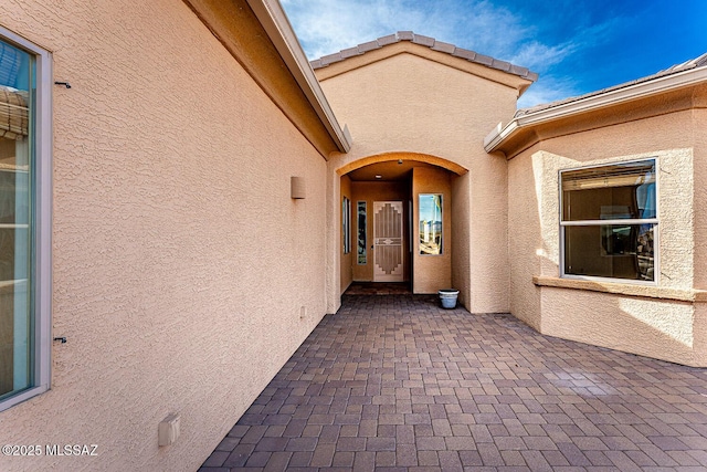 property entrance with a patio area