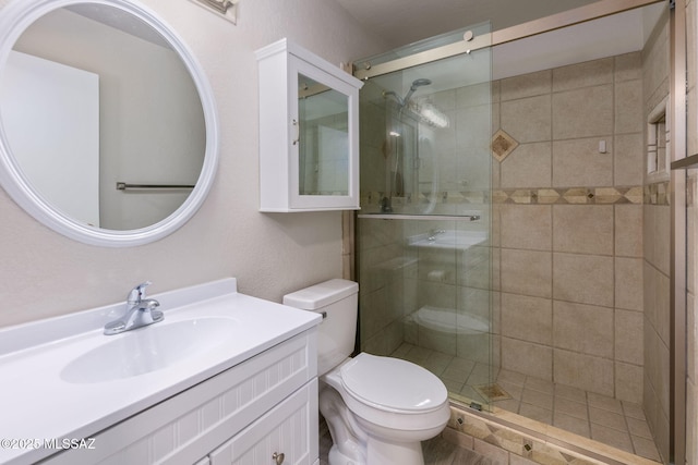 bathroom with vanity, toilet, and walk in shower