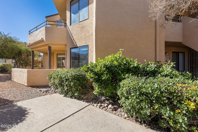 exterior space with a balcony and stucco siding