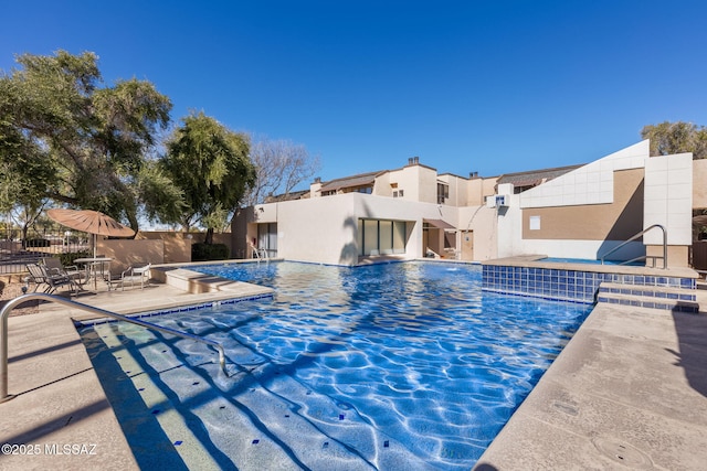 view of swimming pool with a patio area