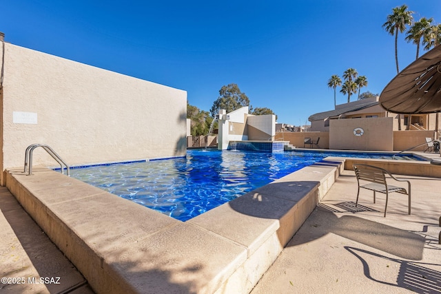 pool featuring fence and a patio